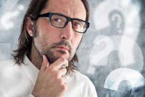 Businessman thinking and questioning. Portrait of thoughtful business person.